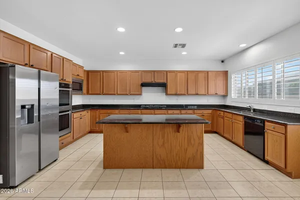 a white stove top oven sitting inside of a kitchen