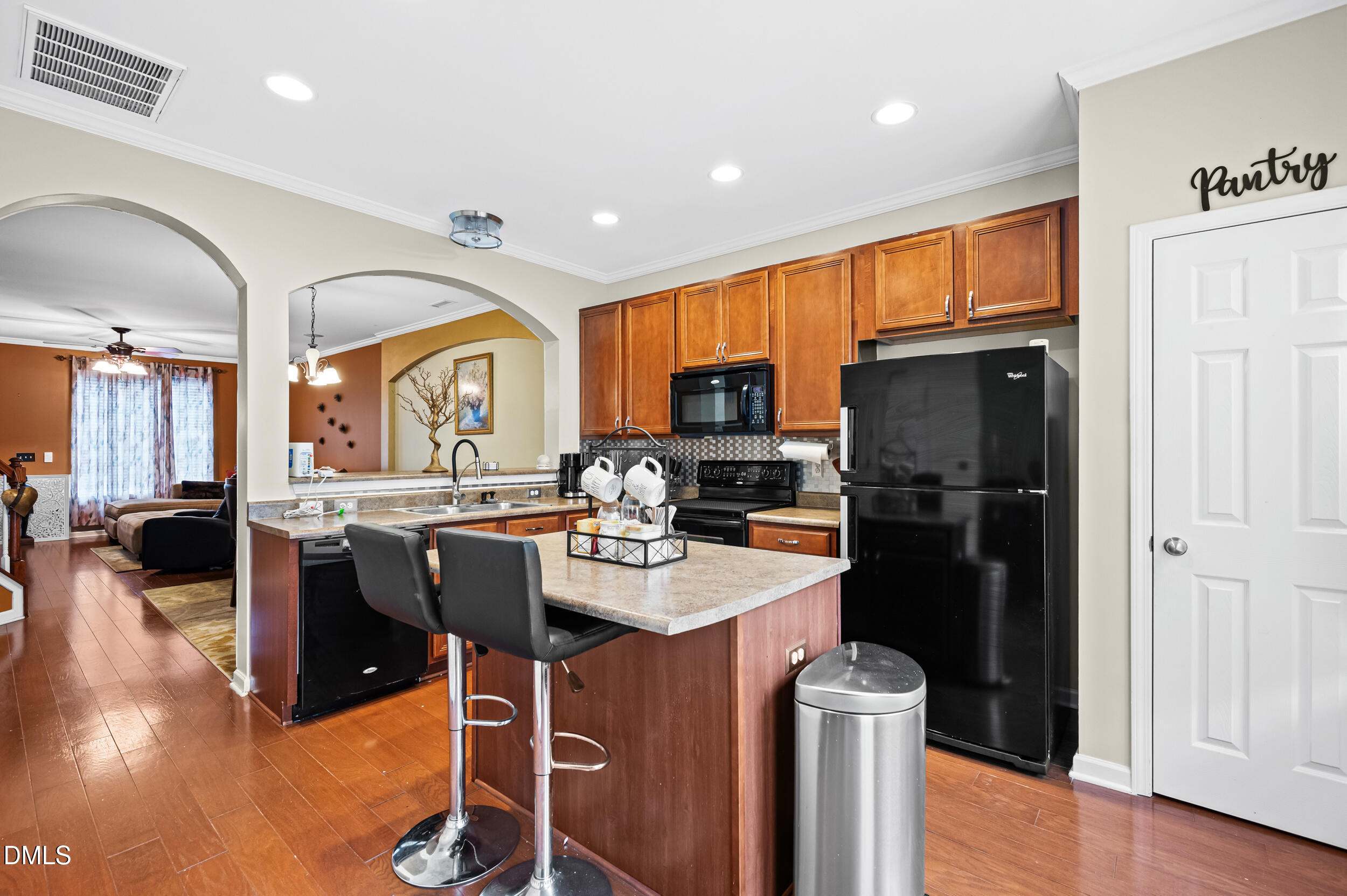 2944 Casona Way Raleigh, NC 27616 - Photo 10 of 24 a kitchen with stainless steel appliances granite countertop a refrigerator a stove top oven a sink dishwasher and wooden cabinets