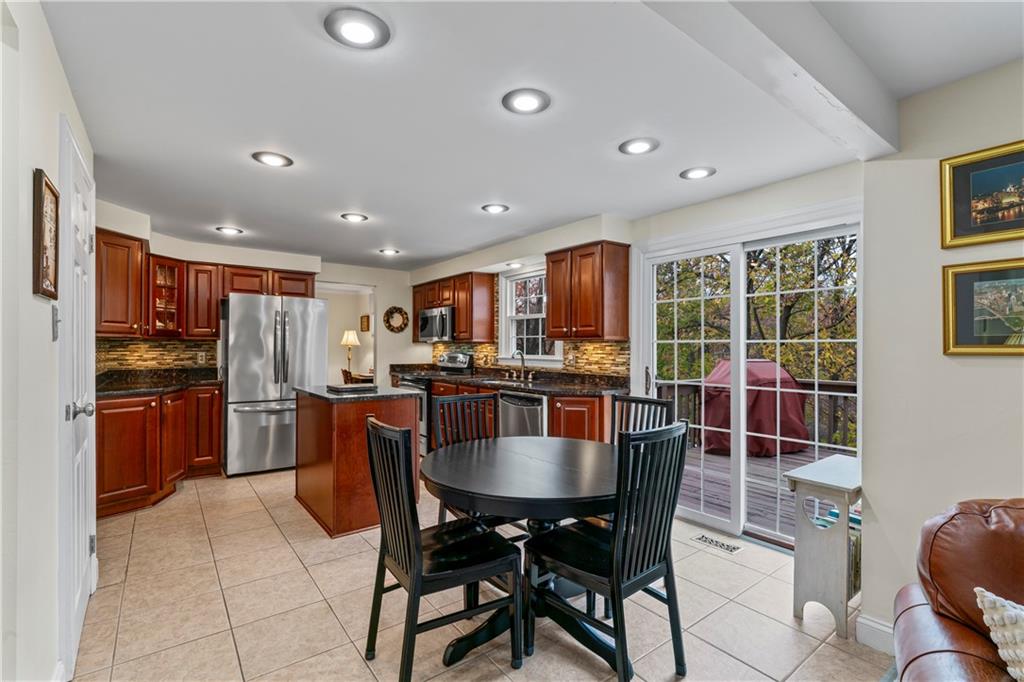 130 Tory Road Coraopolis, PA 15108 - Photo 15 of 50 a kitchen with stainless steel appliances granite countertop a stove a refrigerator a kitchen island a dining table and chairs