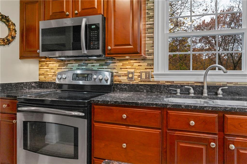130 Tory Road Coraopolis, PA 15108 - Photo 24 of 50 a kitchen with granite countertop a stove sink and cabinets