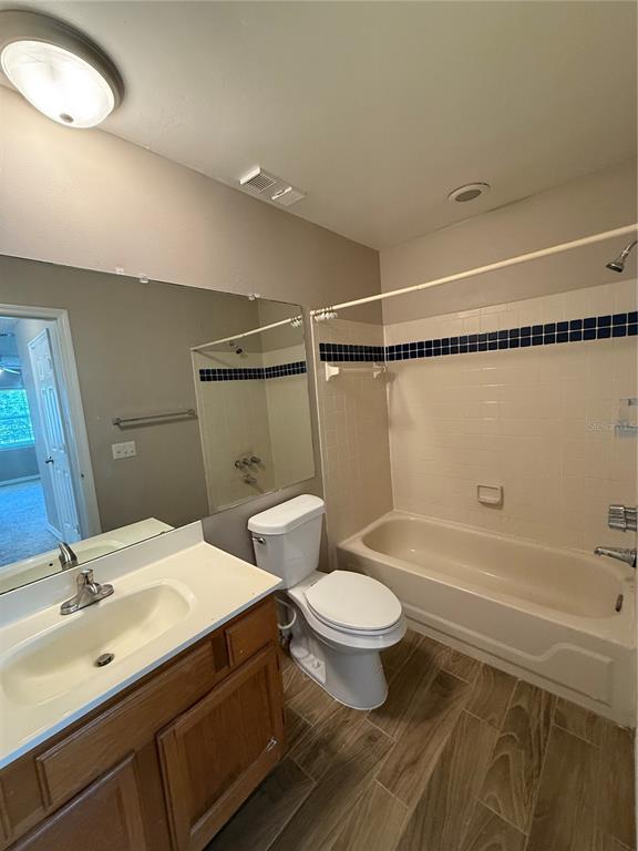 8209 Olympia Court Longwood, FL 32779 - Photo 15 of 29 a bathroom with a double vanity sink a toilet a mirror and shower
