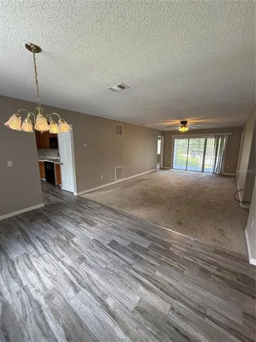 a view of a room with window and hardwood floor