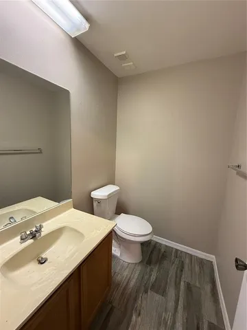 a bathroom with a sink a toilet and a mirror