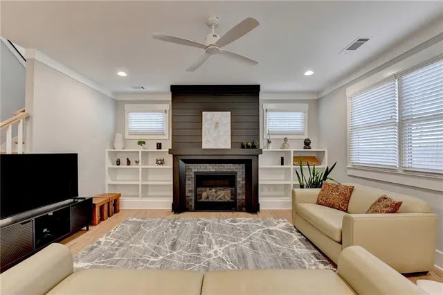 a living room with furniture a fireplace and a flat screen tv
