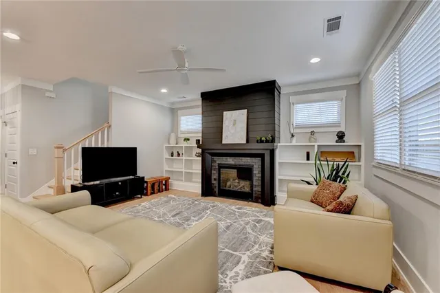 a kitchen with granite countertop a table chairs stainless steel appliances and cabinets