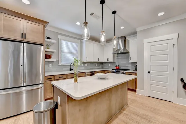 a kitchen with stainless steel appliances granite countertop a sink and a white cabinets