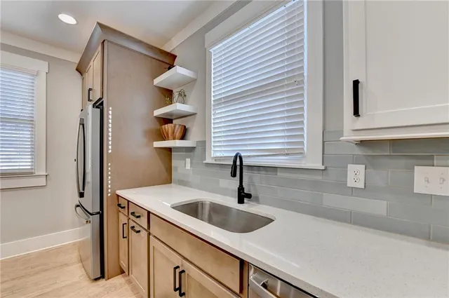 a kitchen with white cabinets and white appliances