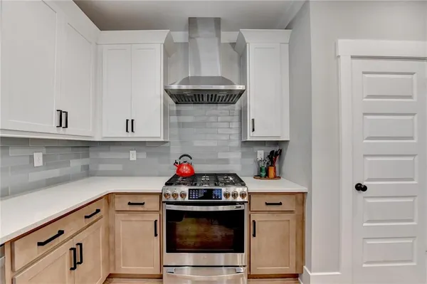 a kitchen with kitchen island a stove a table a sink a refrigerator and chairs