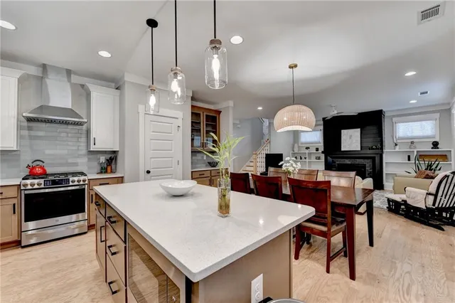 a kitchen with kitchen island granite countertop a sink stainless steel appliances and cabinets
