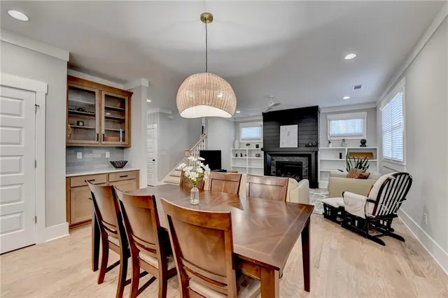 a kitchen with stainless steel appliances granite countertop a sink window and cabinets