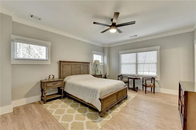 a bedroom with a bed and a ceiling fan