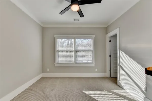a bedroom with a bed window and a desk