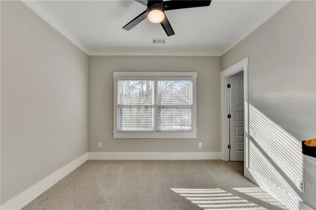 a bedroom with a bed window and a desk