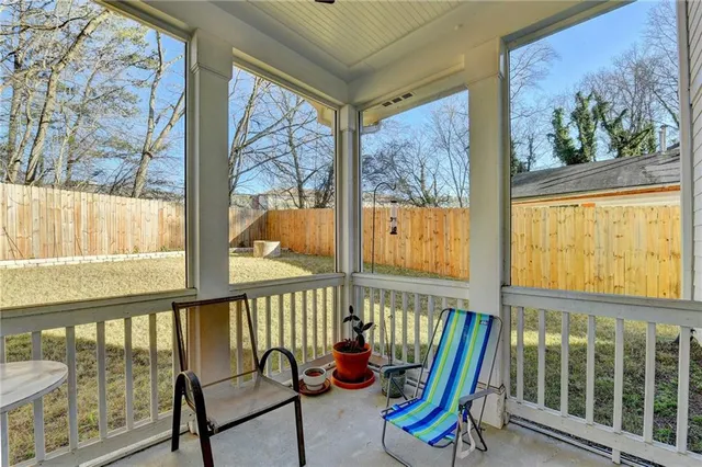 a view of a house with a yard and large tree
