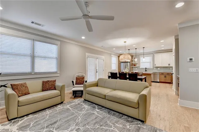 a living room with furniture and a view of kitchen
