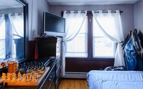 381 Washington Street Melrose, MA 02176 - Photo 23 of 26 a bedroom with a bed next to a window