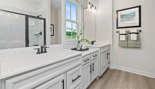 a bathroom with double vanity sink and a mirror