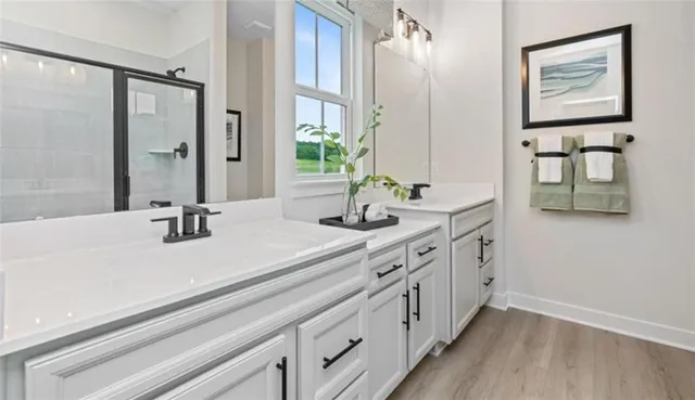 a bathroom with double vanity sink and a mirror