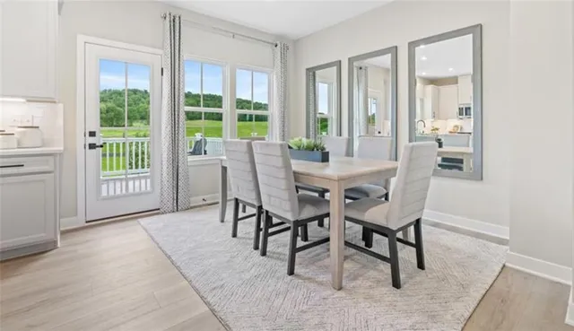 a view of a dining room with furniture and windows