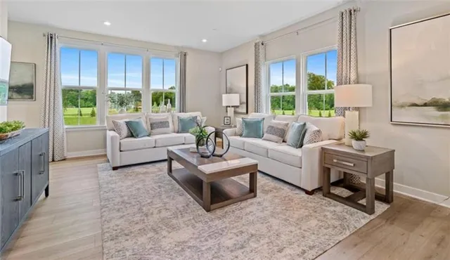 a living room with furniture and a large window