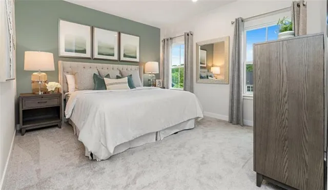 a bedroom with a bed a mirror and a window