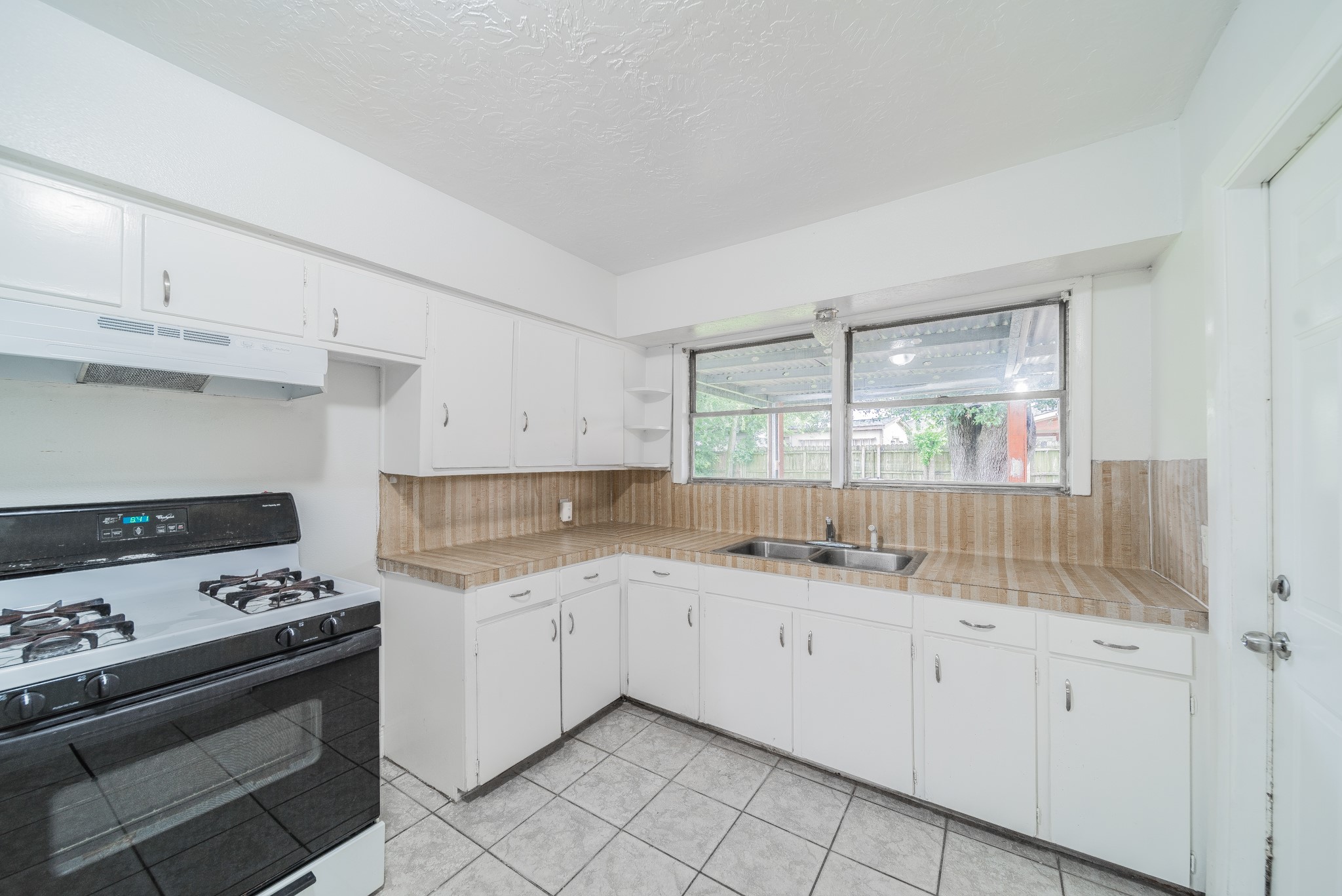 415 Gober Street Houston, TX 77017 - Photo 5 of 12 a kitchen with a sink stove and cabinets
