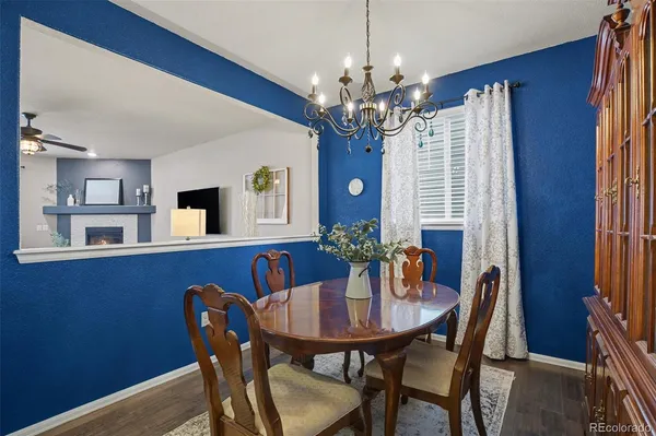 a view of a dining room with furniture and chandelier