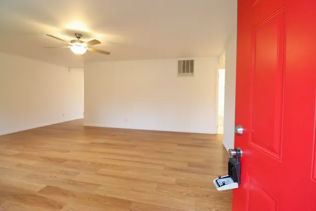 a view of a livingroom with an empty space and a ceiling fan