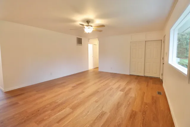 wooden floor in an empty room with a window