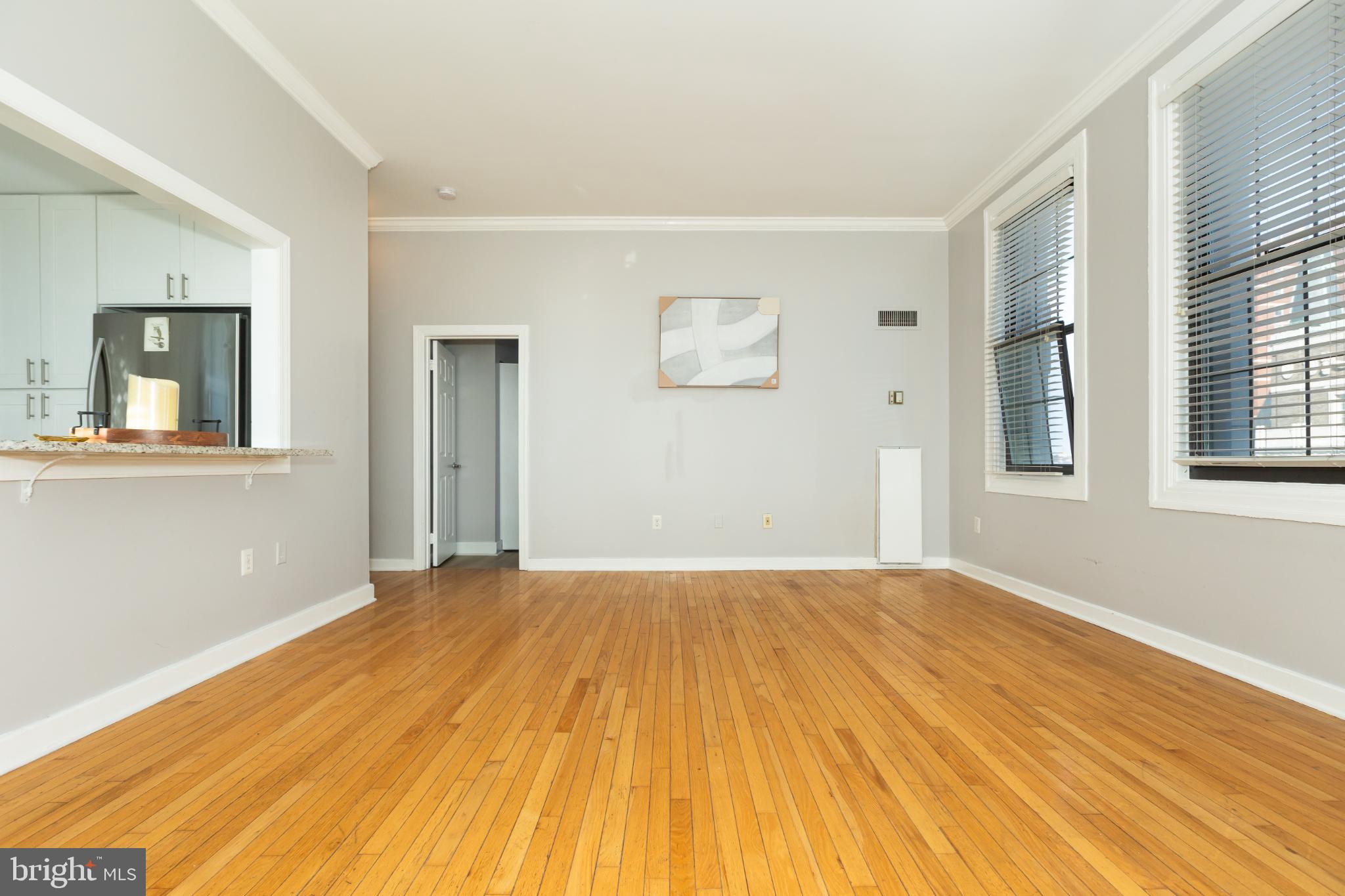 1 East Chase Street, Unit 712 Baltimore, MD 21202 - Photo 23 of 49 Spacious, sunlit room with hardwood floors.