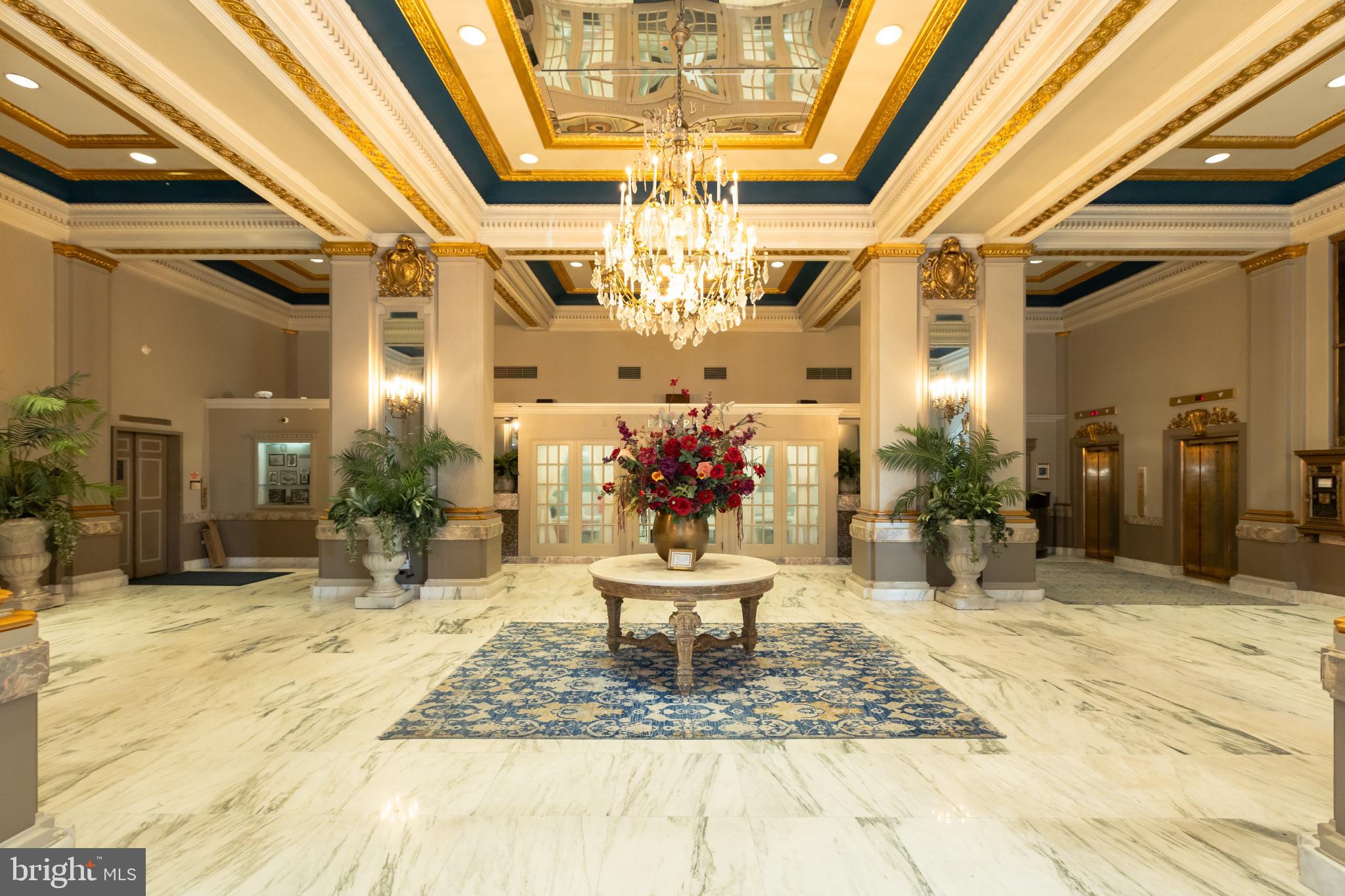 1 East Chase Street, Unit 712 Baltimore, MD 21202 - Photo 3 of 49 Elegant lobby with grand chandelier and decor.