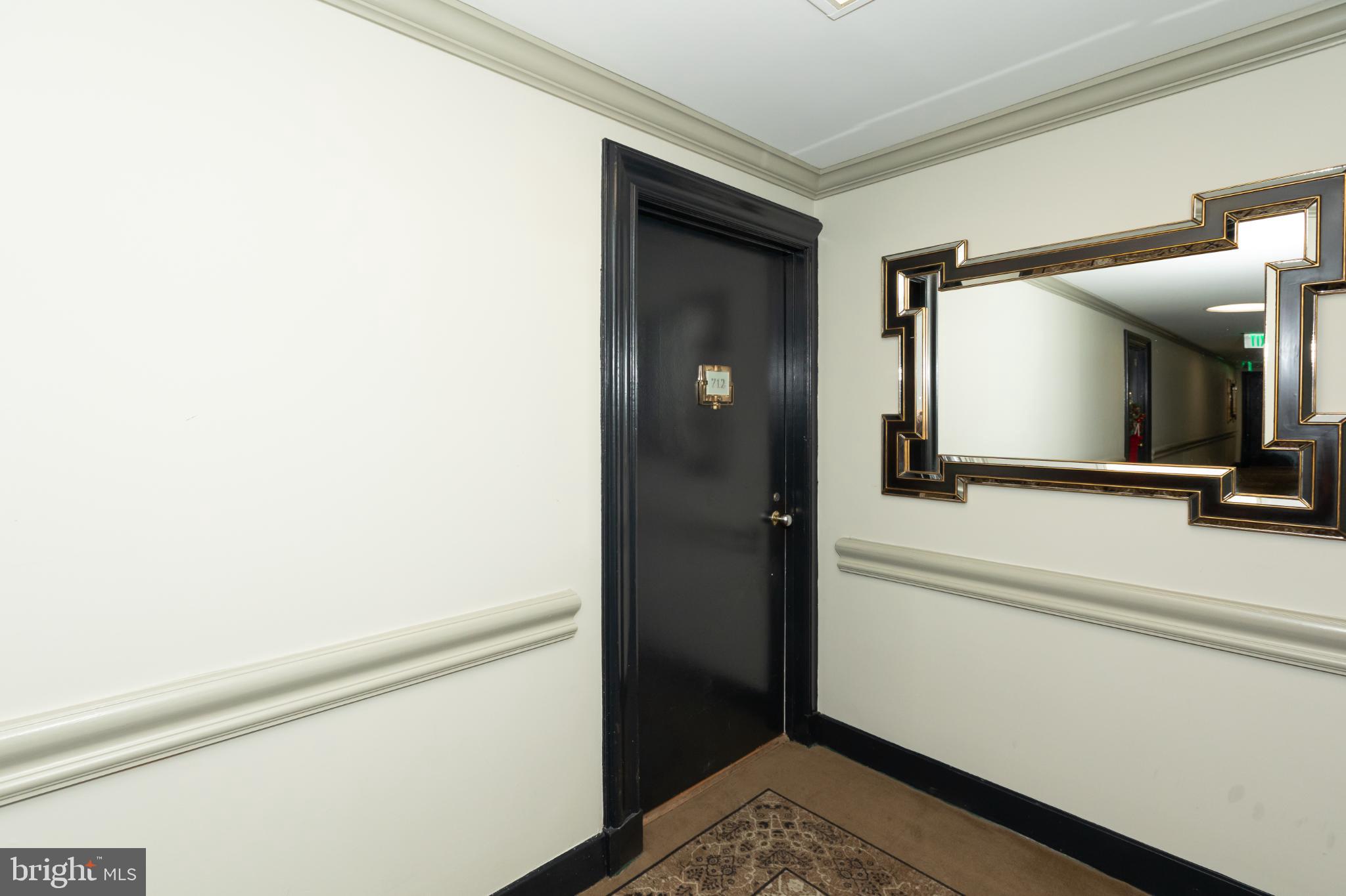 1 East Chase Street, Unit 712 Baltimore, MD 21202 - Photo 43 of 49 Elegant hallway with a stylish mirror.