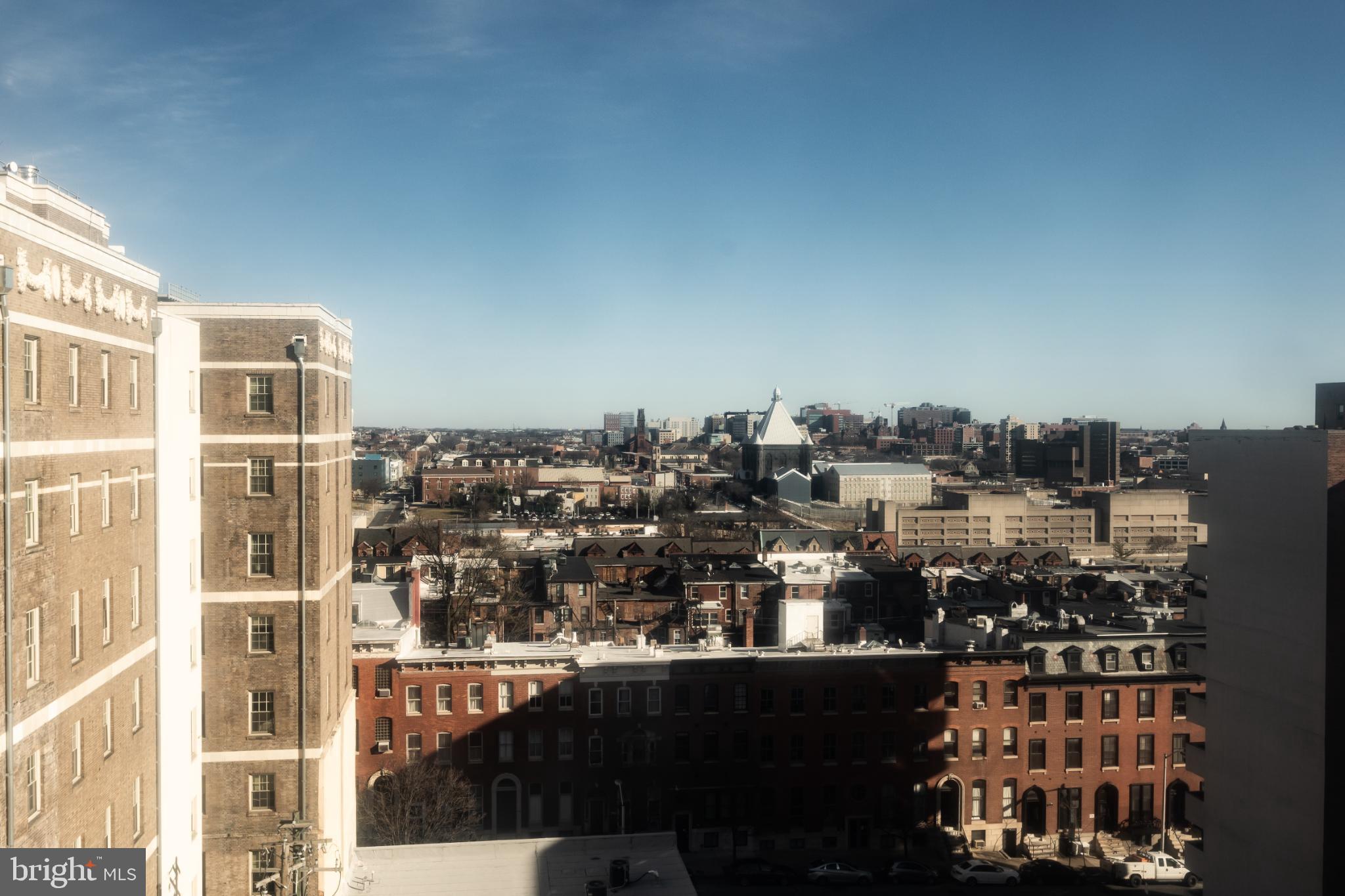 1 East Chase Street, Unit 712 Baltimore, MD 21202 - Photo 49 of 49 Urban skyline under a clear blue sky.