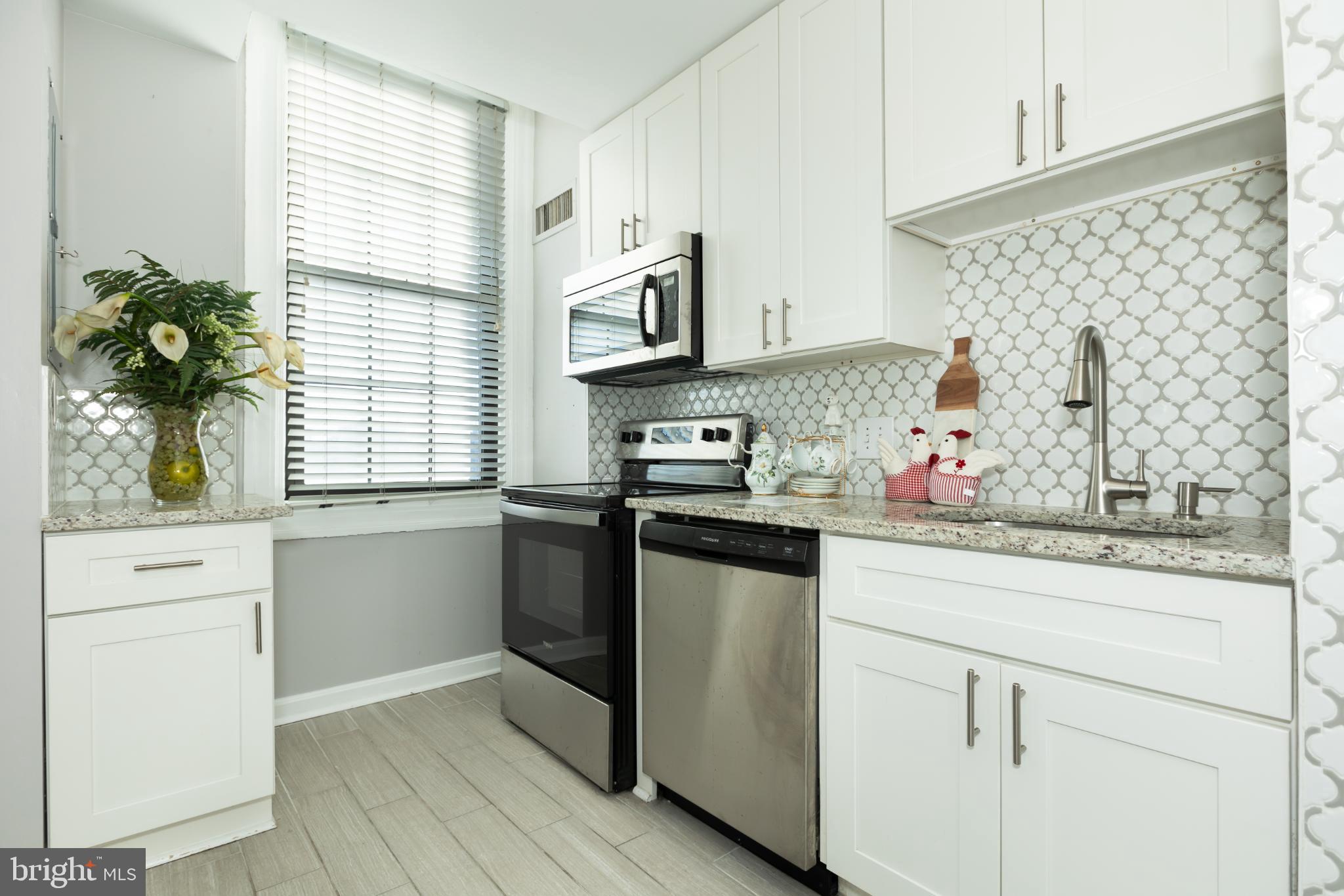 1 East Chase Street, Unit 712 Baltimore, MD 21202 - Photo 8 of 49 Modern kitchen with sleek finishes and light.