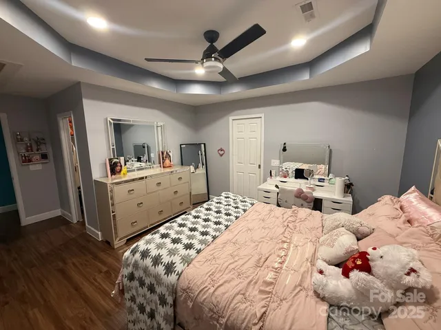 a room with a sink a mirror and cabinets