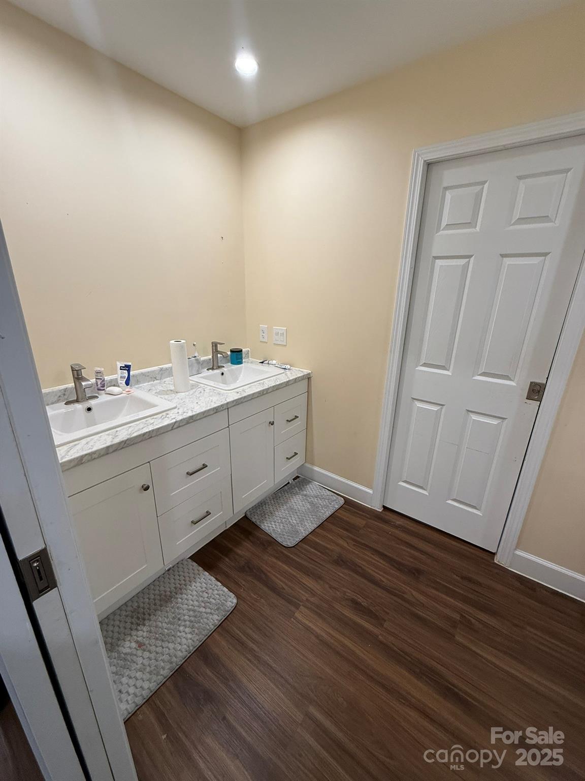 10116 Robert Bost Road Midland, NC 28107 - Photo 15 of 32 a room with a sink a mirror and cabinets