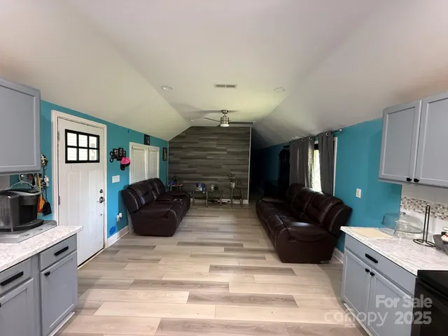 a living room with furniture fireplace and flat screen tv