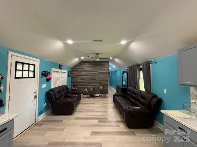 a living room with furniture and a mirror