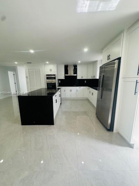 11870 Southwest 5th Street, Unit 1 Miami, FL 33184 - Photo 14 of 38 a large kitchen with a large counter top stainless steel appliances and cabinets