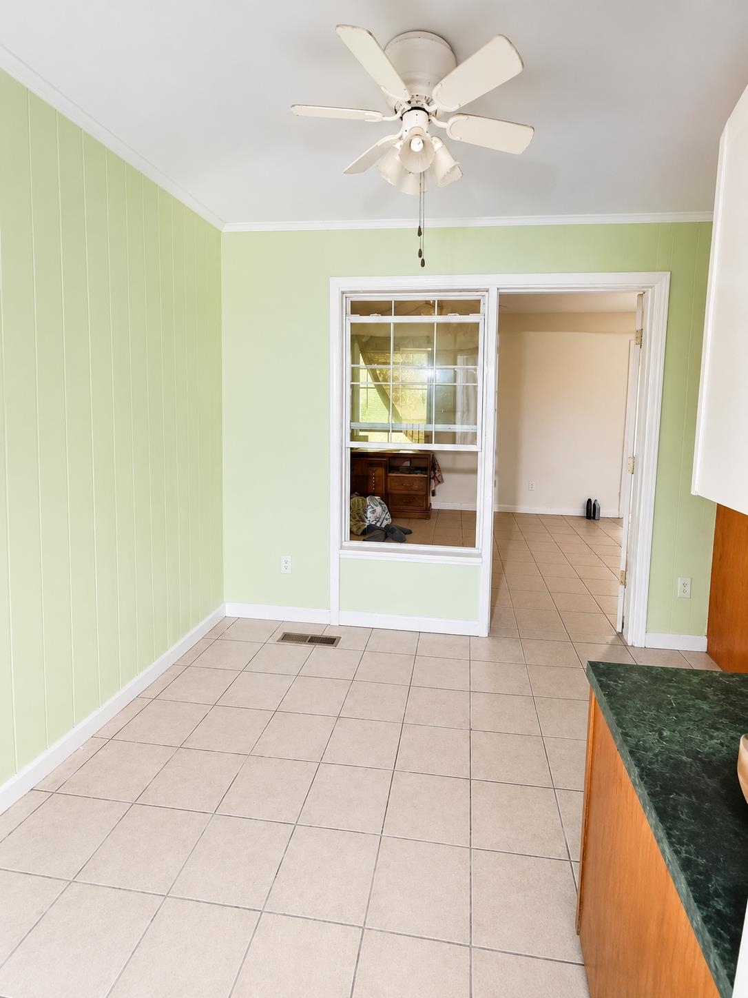 1299 Locke Cuba Road Millington, TN 38053 - Photo 12 of 28 Interior space featuring ceramic tile flooring, a ceiling fan with light fixture, and vertical paneling on walls