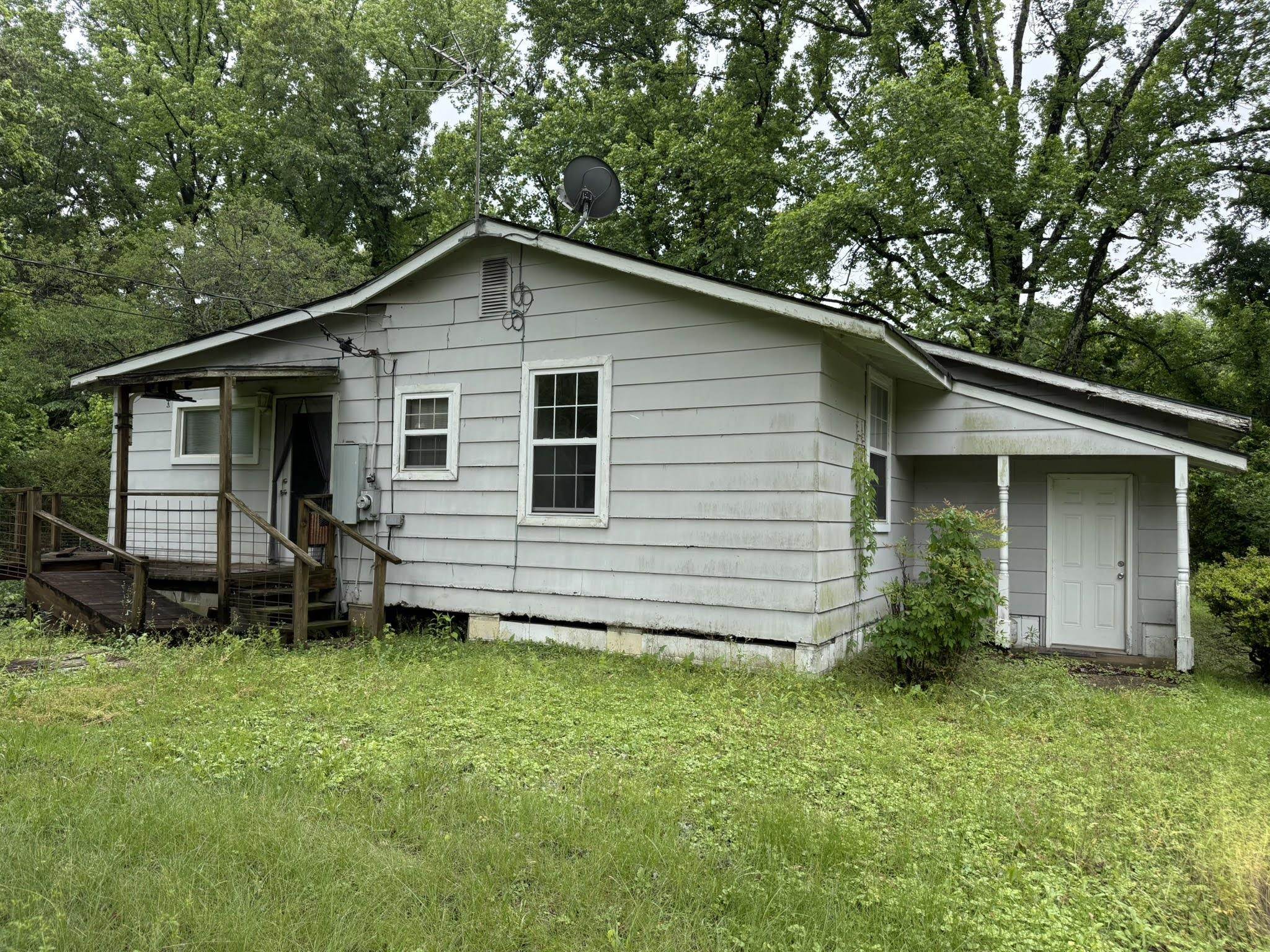 1299 Locke Cuba Road Millington, TN 38053 - Photo 24 of 28 Light grey siding exterior with a partial covered front porch and a secondary covered entry with wooden railing