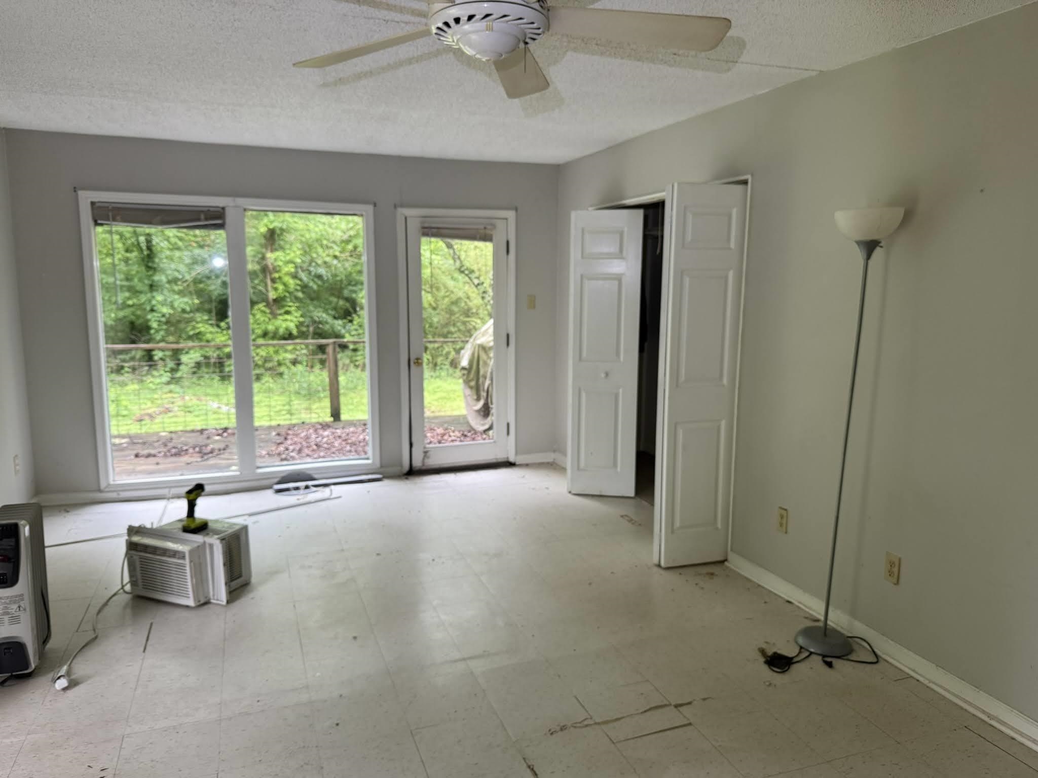 1299 Locke Cuba Road Millington, TN 38053 - Photo 5 of 28 Room featuring a ceiling fan, light gray wall paint, and double bi-fold doors