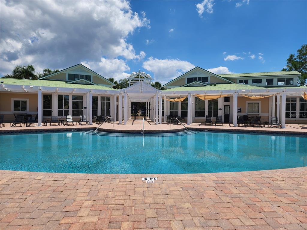 4802 51st Street West, Unit 1418 Bradenton, FL 34210 - Photo 15 of 20 a view of a house with swimming pool and porch