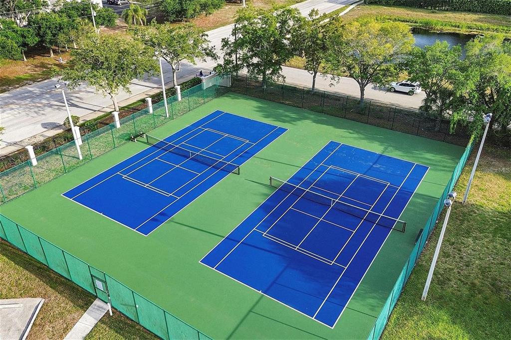 4802 51st Street West, Unit 1418 Bradenton, FL 34210 - Photo 16 of 20 a view of a tennis ground with large trees
