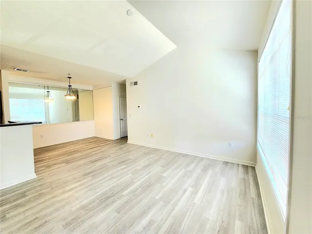 a view of an empty room and wooden floor