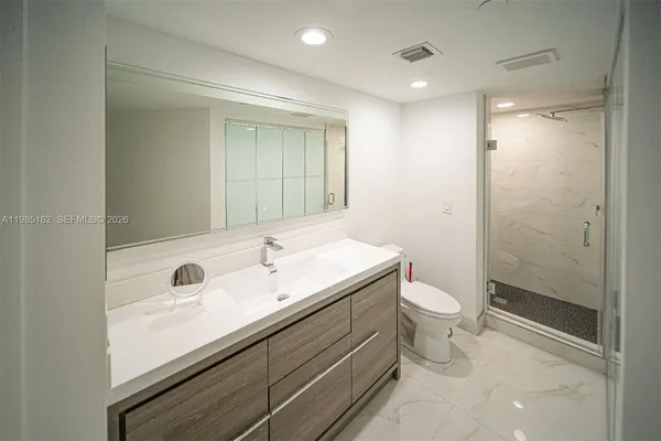 a view of a bathroom with washer and dryer