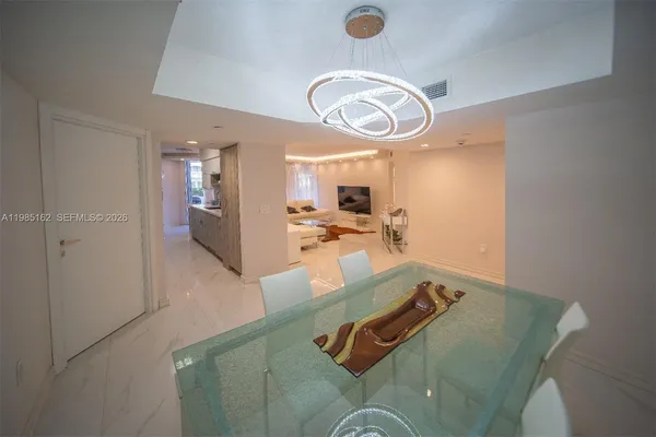 a kitchen with counter top space a sink a refrigerator and cabinets