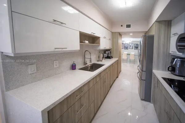 a kitchen with stainless steel appliances a refrigerator and a stove