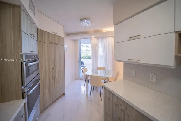 a kitchen with stainless steel appliances and cabinets