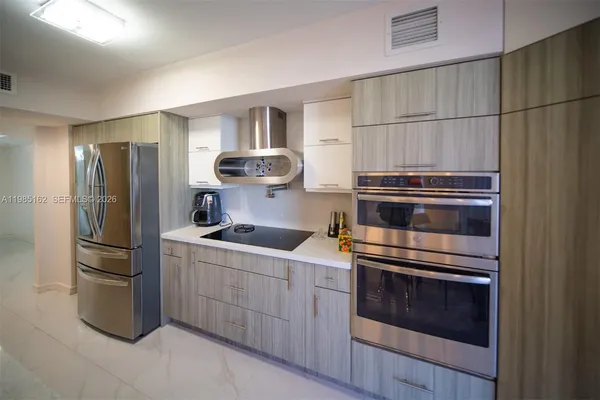 a kitchen with a sink and a refrigerator
